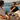 Two men sipping espresso by a pool with a coastal ocean view and a Doble Oscuro Discovery Bag laid flat on the table.