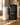 White 16oz #fueledbyCOFFEE tumbler beside a Stephen James Sierra Ember Medium Roast coffee bag on a warm wood surface with scattered coffee beans.