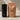 The Repose tumbler in obsidian black next to a bag of Stephen James Serena Claro decaf coffee
