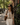 A woman carrying The Repose tumbler while walking on a city street